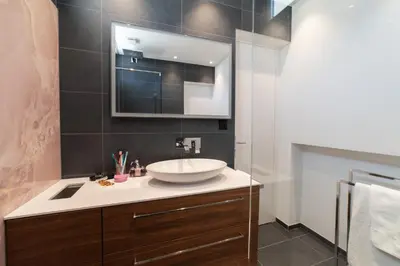 a bathroom with a sink and a mirror at Alpstein in Wildhaus