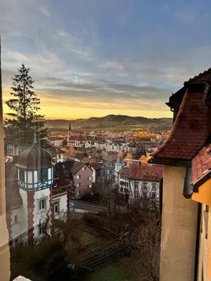 a view of a city at sunset with buildings at Modernes, renoviertes Apartment nähe dem Zentrum kostenloses Parken in St. Gallen