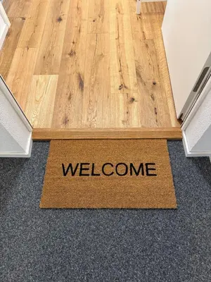 a welcome mat on the floor of a room at Modernes, renoviertes Apartment nähe dem Zentrum kostenloses Parken in St. Gallen