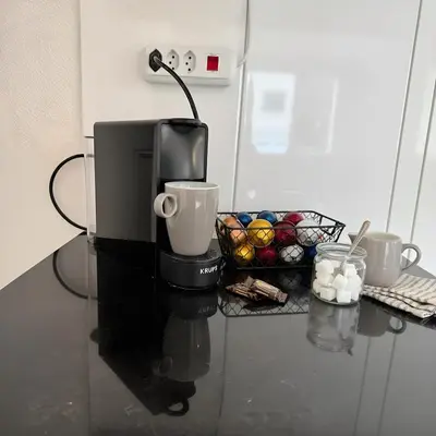 a coffee maker on a counter with a basket of muffins at Modernes, renoviertes Apartment nähe dem Zentrum kostenloses Parken in St. Gallen