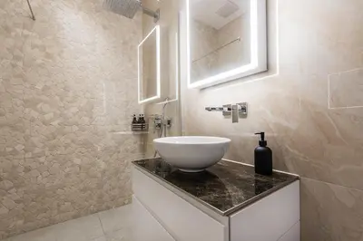 a bathroom with a white bowl sink on a counter at DESIGN-STUDIO 3 !Gratis Parken, Free Parking! in Kreuzlingen