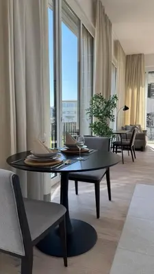 a living room with a table and a large window at DESIGN-STUDIO 4 !Gratis Parken, Free Parking! in Kreuzlingen