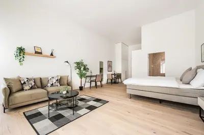 a living room with a bed and a couch and a table at DESIGN-STUDIO 2 !Gratis Parken, Free Parking! in Kreuzlingen