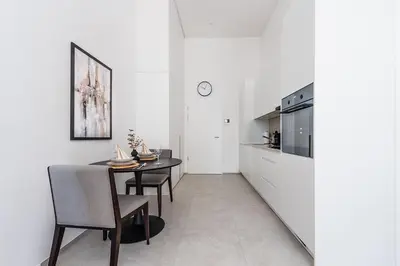 a kitchen and dining room with white walls and a table and chairs at DESIGN-STUDIO 2 !Gratis Parken, Free Parking! in Kreuzlingen