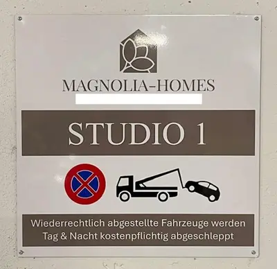 a sign for ahibula homes and a sign for a car at DESIGN-STUDIO 1 !Gratis Parken, Free Parking! in Kreuzlingen