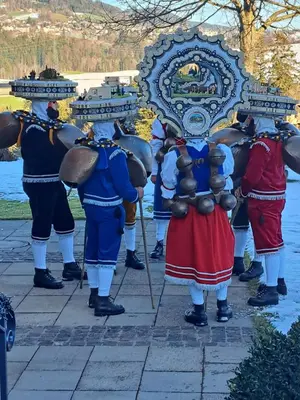 a group of people in costumes standing in front of a mirror at Strickerhof in Hundwil