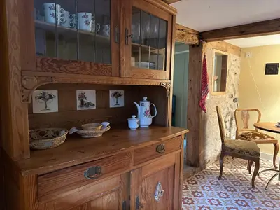 a wooden cabinet with dishes on top of it at Historic Swiss Room in Guesthouse Rosalie in Brunnadern