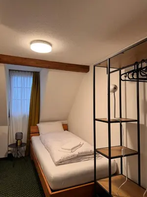 a bedroom with a bunk bed with white sheets at Schiff Kesswil in Kesswil