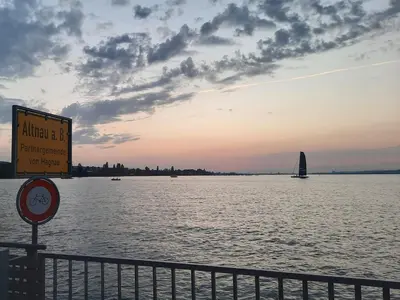 a sign next to a body of water with a sail boat at Kaffeegasse 11 - Holiday home with heart on Lake Constance in Altnau
