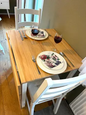 a wooden table with two glasses of wine on it at Klara 0002 - Olma, Spital, Uni St- Gallen in St. Gallen