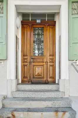a wooden door on a house with stairs at Klara 0002 - Olma, Spital, Uni St- Gallen in St. Gallen