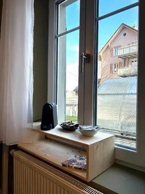 a window with two bowls on a wooden window sill at Klara 0002 - Olma, Spital, Uni St- Gallen in St. Gallen