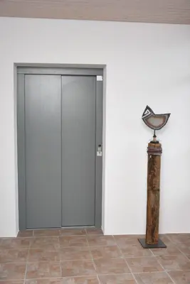 a door in a white wall next to a pillar at Towerhotel in Waldkirch