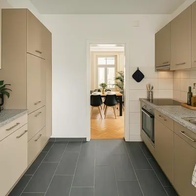 a living room with a couch and a tv at OLMA Center Barrock Suites in St. Gallen