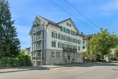 a large white building on the side of a street at Klara 1014 - Olma, Spital, Uni St- Gallen in St. Gallen