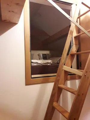 a ladder leading up to a bunk bed with a mirror at Haus Ritzlisjokes in Weissbad