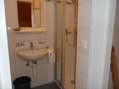 a bathroom with a sink and a shower at Wenk Elisabeth in Wildhaus