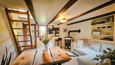 a living room with a table and a couch at Zum Wöschhüsli mit Sauna in Rheineck