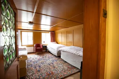 a hotel room with two beds and a window at Wohnhaus Münzmühle in Appenzell in Appenzell