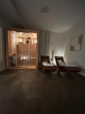 an empty room with two beds in a room with a window at S-Cape Suite&Spa in Horn