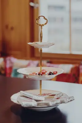 a three tiered plateatter on top of a table at Ferienhaus Lindeli, Luxeriös eifach in Sankt Peterzell