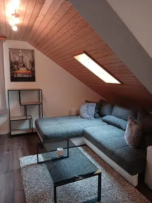 a living room with a couch and a table at 2,5 Zimmer Ferienwohnung in Bühler, Nähe Appenzell in Bühler