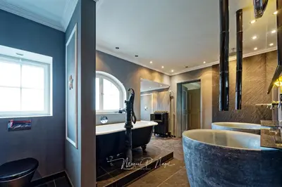 a fitness room with a gym with tread machines at Villa Philipp Plein - Designervilla mit Pool in Amriswil