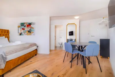 a bedroom with a bed and a table and chairs at VISIMO Apartments Teufenerstrasse St Gallen - Urban, Direct, Close to nature in St. Gallen