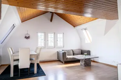 a living room with a table and a couch at Private Apartment in Degersheim