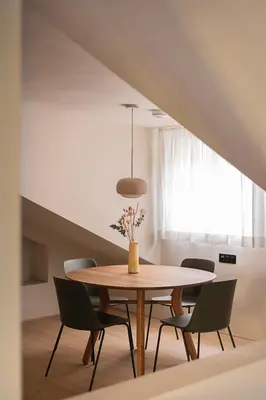 a dining room with a table and chairs at normalkonsum - premium apartments in St. Gallen