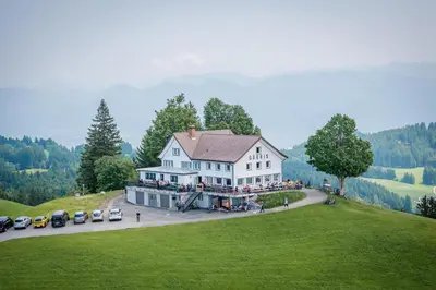 an aerial view of a large white house on a hill at Gasthaus Oberer Gäbris in Gais