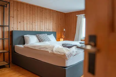a bedroom with a bed in a room with wooden walls at Gasthaus Oberer Gäbris in Gais