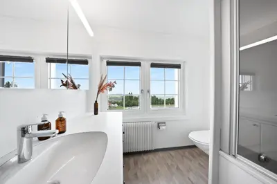 a white bathroom with a sink and a toilet at Gasthaus Oberer Gäbris in Gais