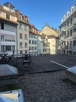 a large parking lot with tables and buildings at Kugelgasse Apartments - Smart Living by Klang und Kleid in St. Gallen