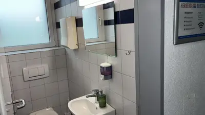 a bathroom with a sink and a mirror at Herberge Seeperle Bistro Rorschach in Rorschach