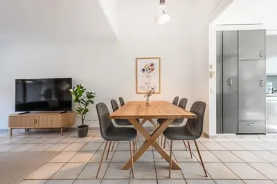 a dining room with a wooden table and chairs at CITY HOUSE !Gratis Parken, Free Parking! in Kreuzlingen