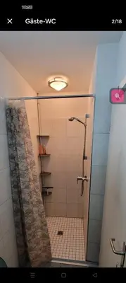 a bathroom with a shower with a shower curtain at Zimmer oberhalb einer Schokoladenfabrik in Kreuzlingen