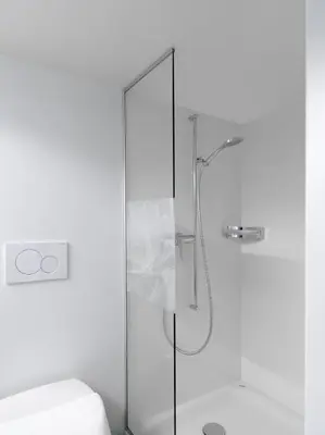 a shower with a glass door next to a toilet at Hotel B&BAlpenheim in Teufen