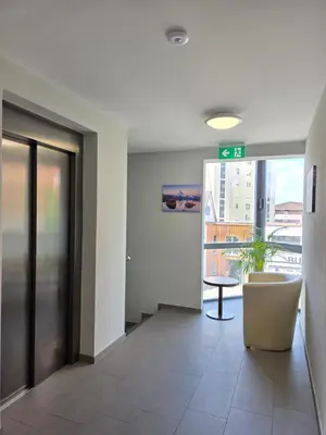 an office hallway with a exit sign and a table at Hotel Salvi in Kreuzlingen