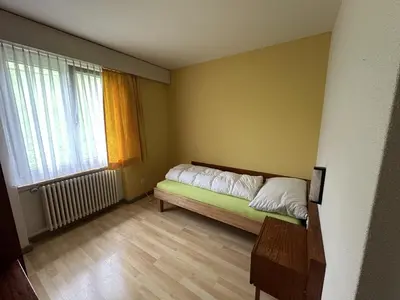 a small bedroom with a bed and a window at Bergnest Wildhaus in Wildhaus