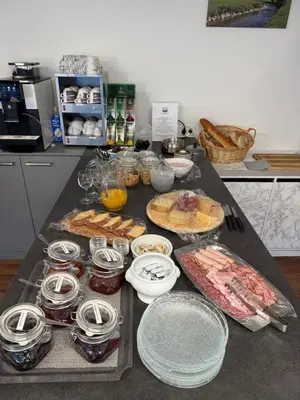 a kitchen counter with a table with food on it at Bergnest Wildhaus in Wildhaus