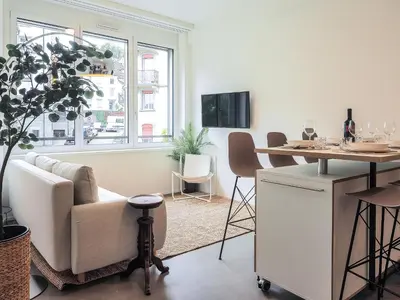 a living room with a couch and a table at WYBA Living - Modernes Apartment - Gratis ÖV - Ruhig & Zentral in St. Gallen