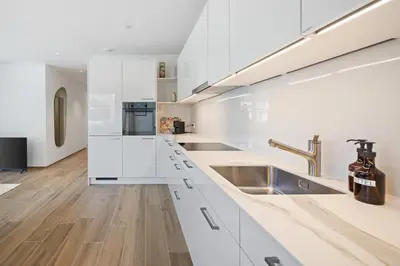 a kitchen with white cabinets and a sink at BLIV Design-Apartment mit Parkplatz, nahe Zentrum in St. Gallen