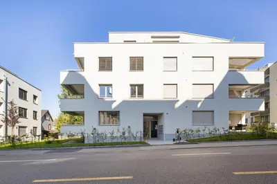 a white building on the side of a street at BLIV Design-Apartment mit Parkplatz, nahe Zentrum in St. Gallen