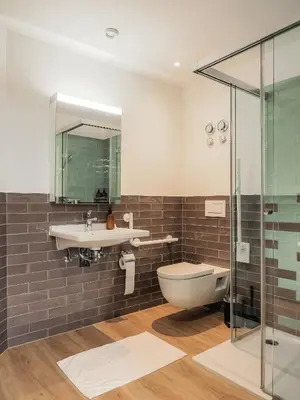 a bathroom with a sink and a toilet and a shower at Stilvoll&zentral in St Gallen -WYBA Living P in St. Gallen