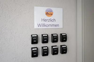 a wall with a bunch of cell phones on a wall at CasaMia Flawil in Flawil