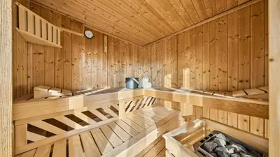 a kitchen with a large counter top and wooden walls at Suite4you Erlen l Privater Pool ganzjährig beheizt & Sauna l 10min zum Bodensee, Parkplatz & WLAN in Erlen