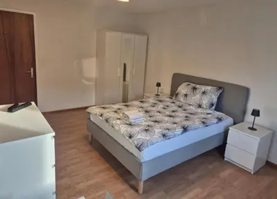 a bedroom with a bed and two night stands at SwissRest - Self Check-In in Sevelen
