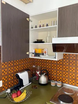 a kitchen with a sink and a counter with fruits at SwissRest - Self Check-In in Sevelen