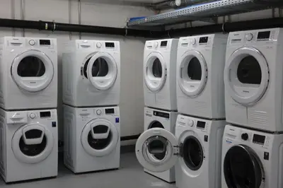 a group of washing machines and washers in a laundry room at Modernes Hostel, Privatzimmer in Shared Apartment, WYBA Living in St. Gallen